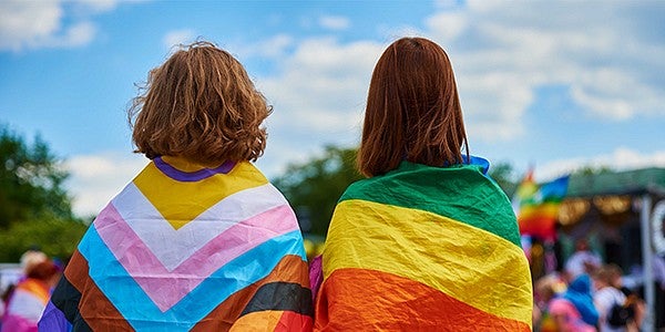 lgbtq flag draped around students