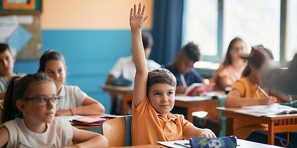 student raising hand in class