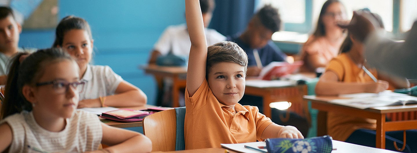 student raising hand in class