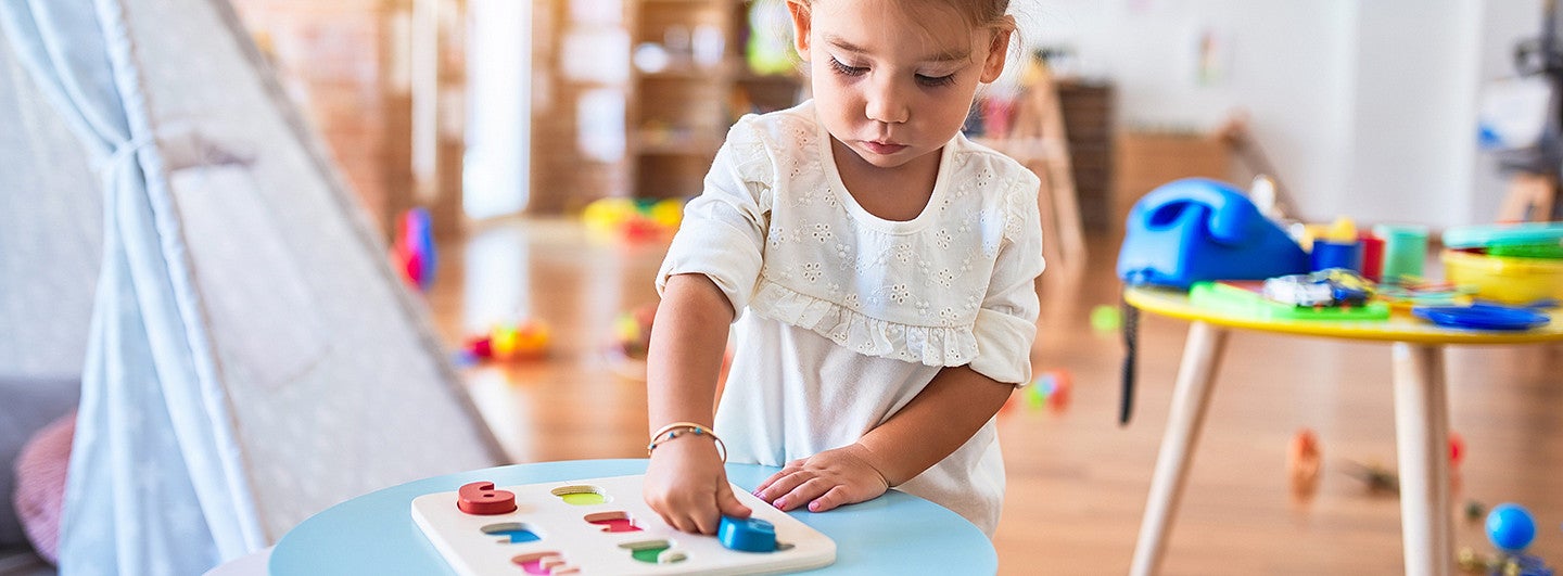 young girl working on math in school