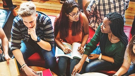 A group of high school students talking and smiling
