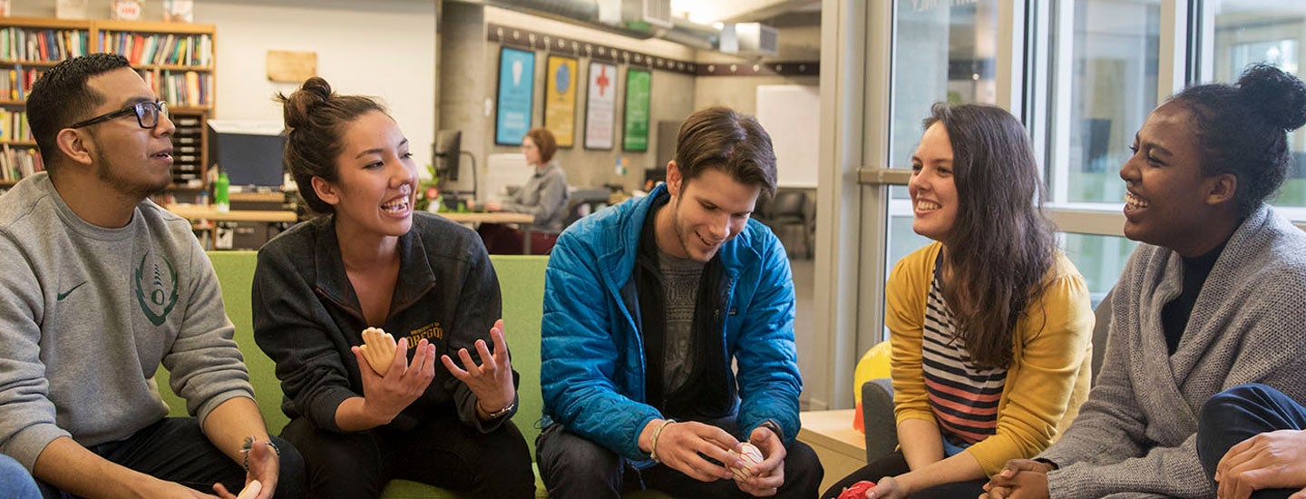 Students im discussion on couches in Holden Center lobby.