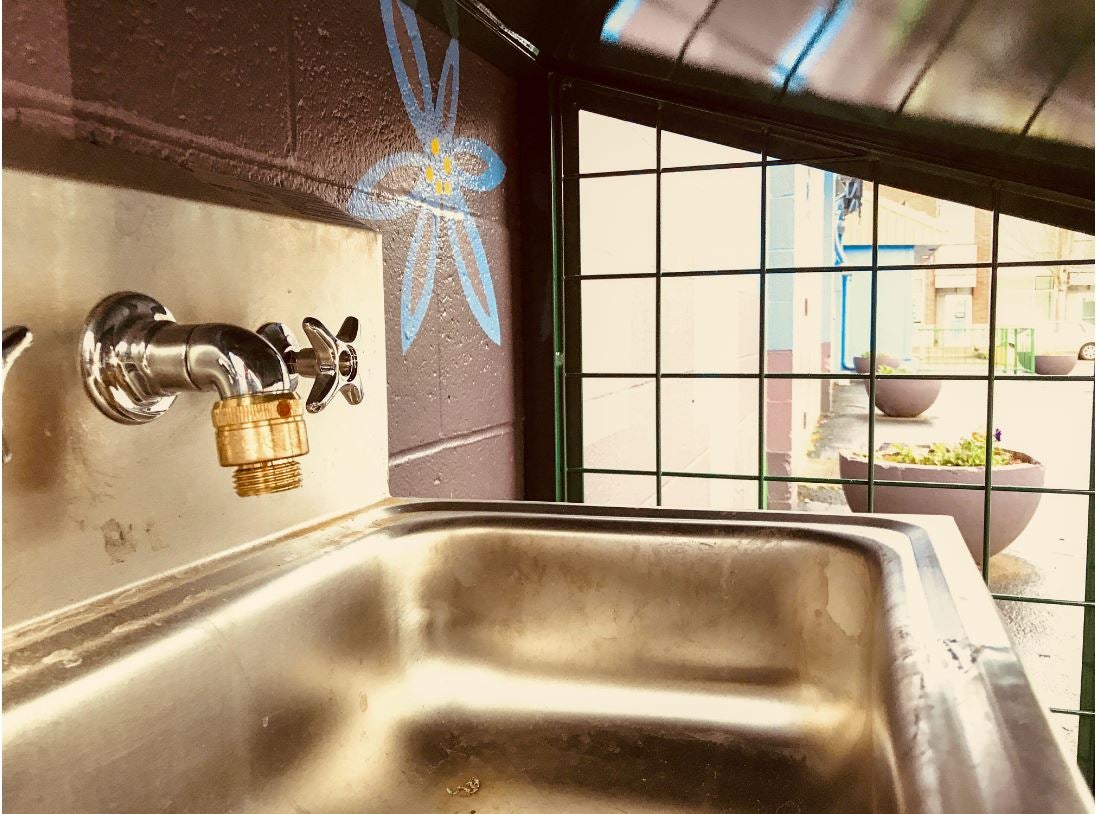Faucet over silver sink.
