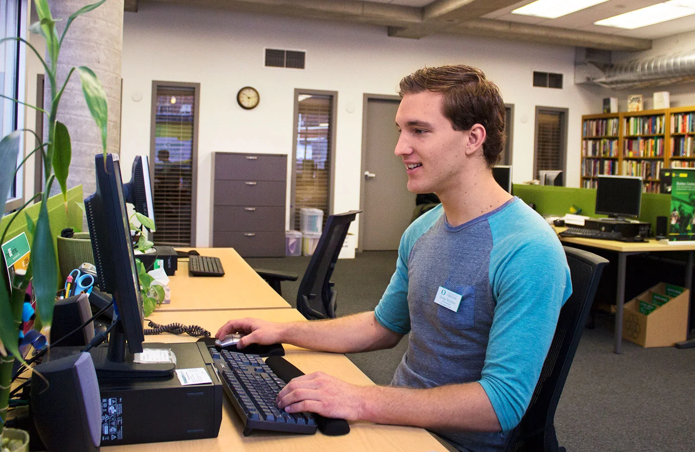A student employee working on a computer in the Holden Center.