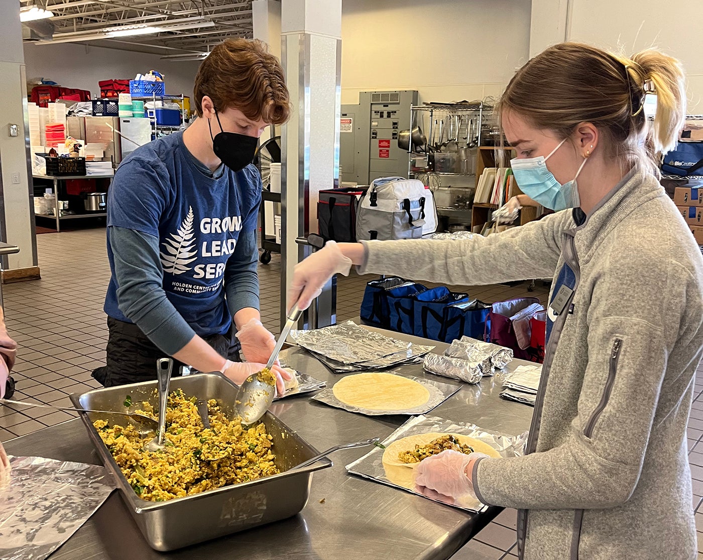 Students volunteer, making burritos for a local organization