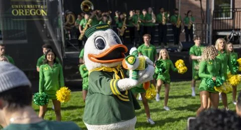 The Duck plays with a small stuffed Duck