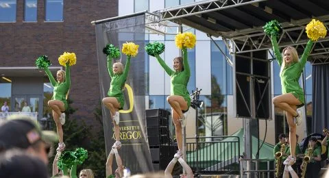 Members of the UO cheer squad are held in the air