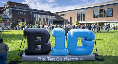 A large inflatable Big Ten logo sits on the EMU Green