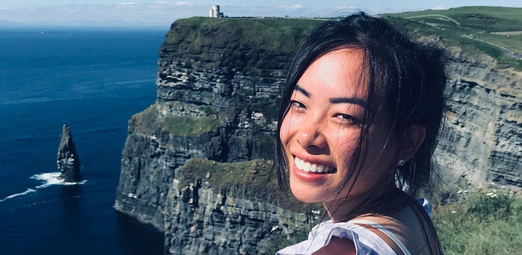 (A student stands near the cliffs in Ireland, posing and smiling.) Irish Cultural Studies in Galway