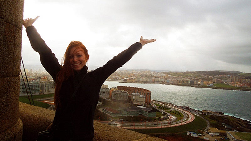 Student posing in front of view of a city below) Student Exchange Programs