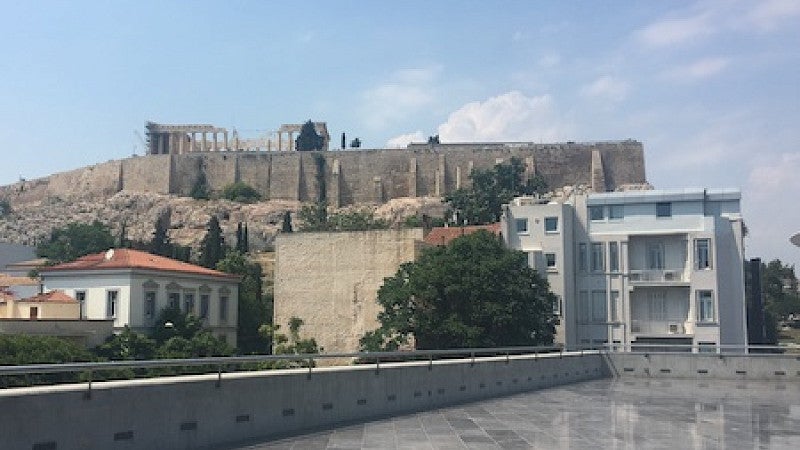 Ancient and modern buildings side by side in a cityscape.