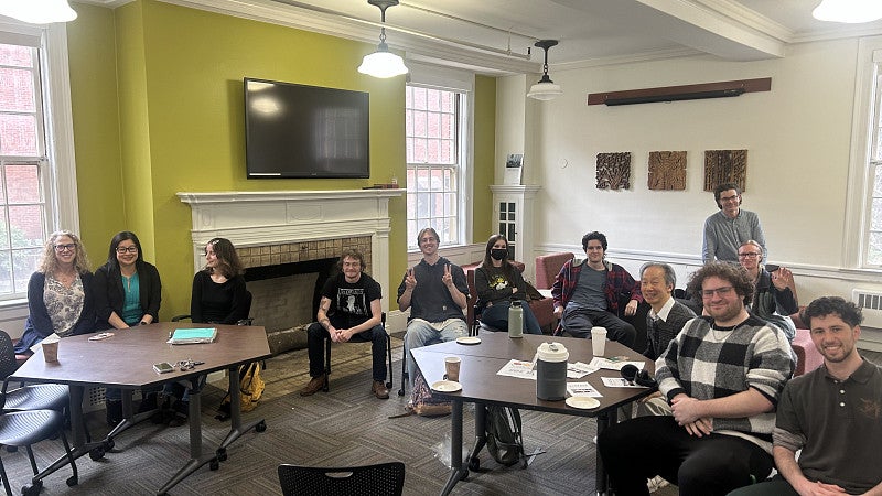 Students engaging in a presentation and smiling 