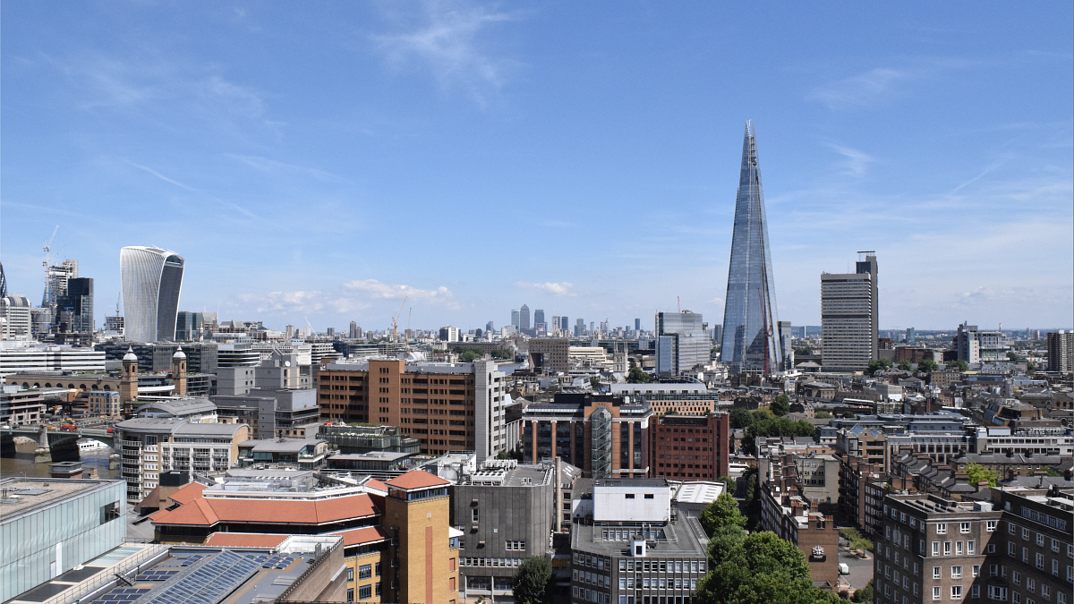 The skyline of London under blue skies on a sunny day.