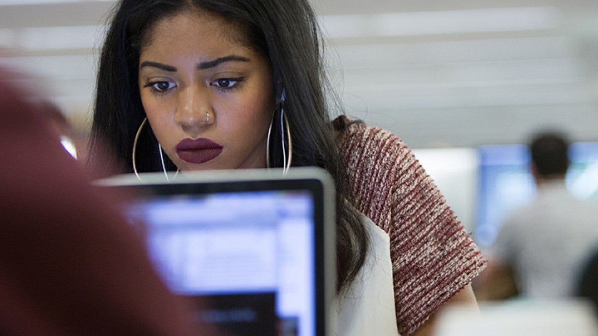 Graduate student focused on work in a classroom.