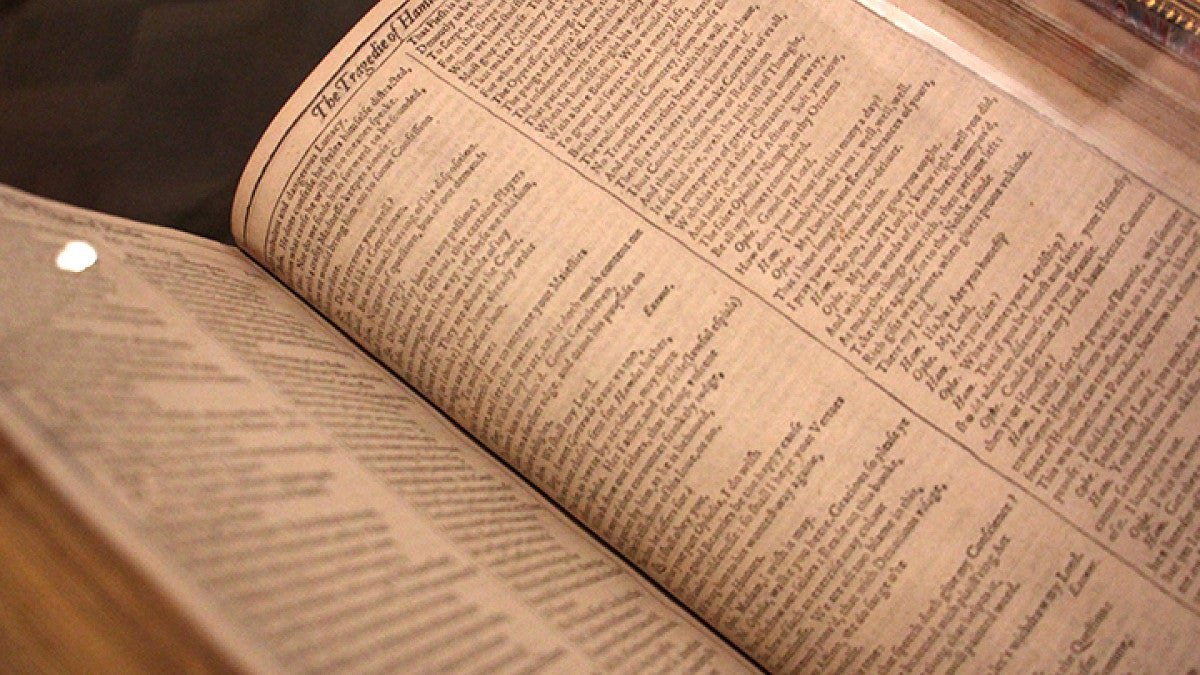 Open book displaying pages from Shakespeare's Macbeth.