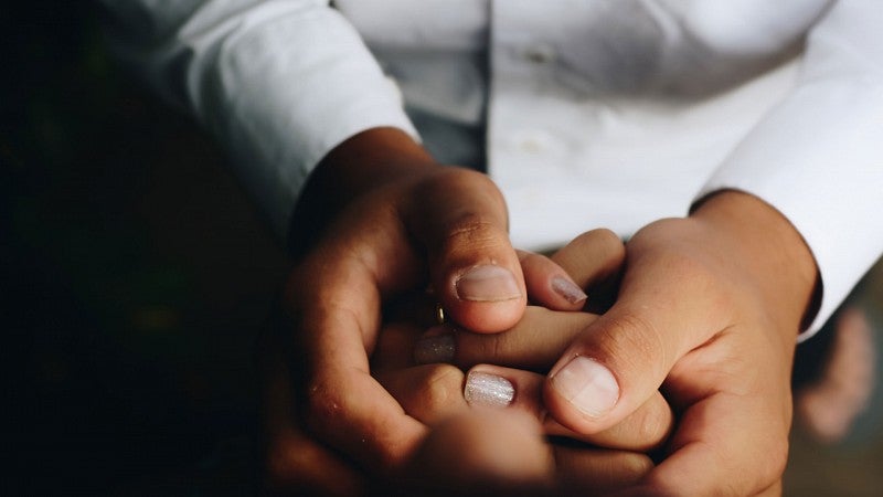 Person holding hands with other smaller hands