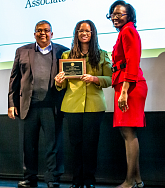 Photo of Doneka Scott receiving their award
