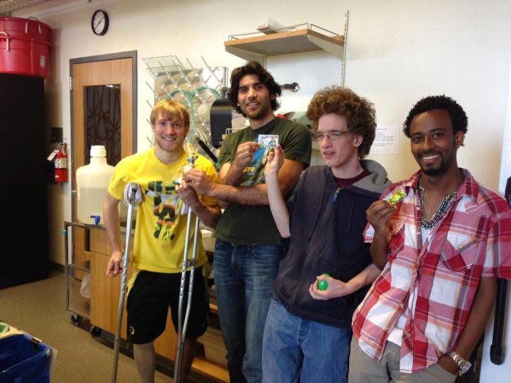 A group of undergraduate researchers pose in a lab.