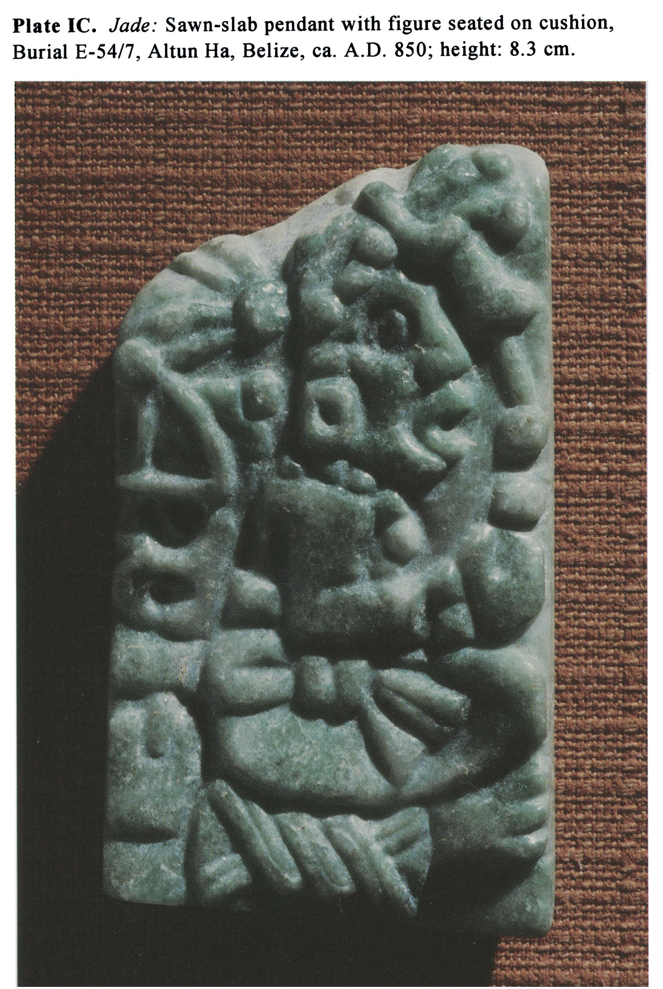 Plate IC Jade: Sawn-slab pendant with figure seated on cushion, Burial E-54/7, Altun Ha, Belize, ca. A.D. 850; height: 8.3 cm.