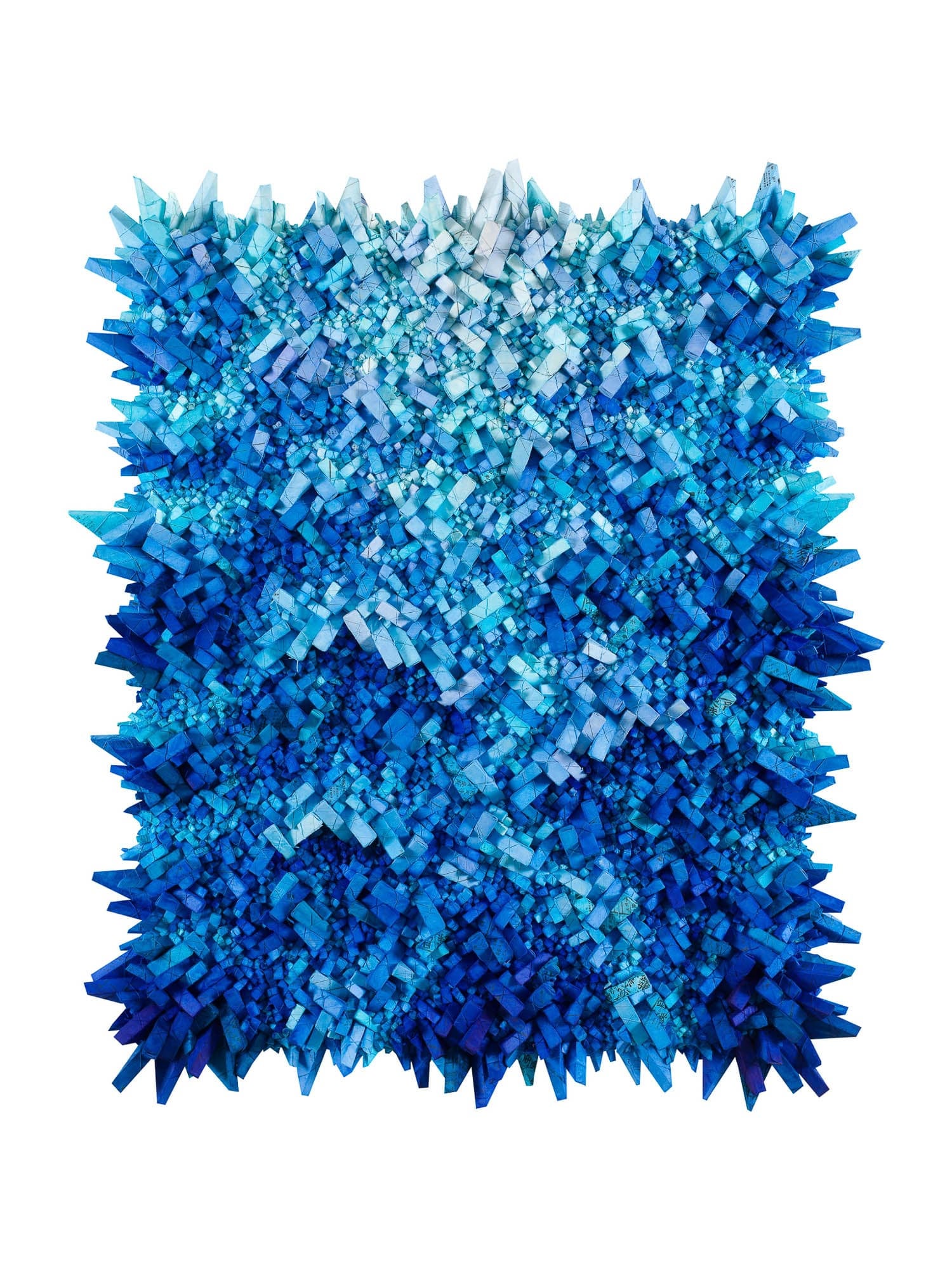 An abstract artwork featuring a dense cluster of blue geometric shapes creating a textured surface.