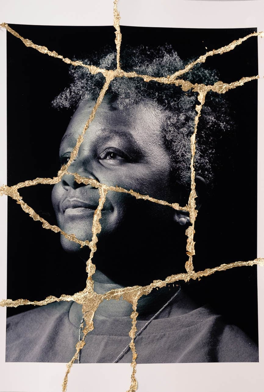 Black and white portrait of a person with short curly hair, with gold lines running across the image like cracks.