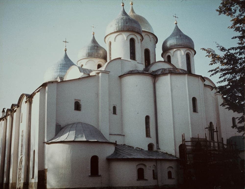 Photograph of the Cathedral of Hagia Sophia in Novgorod, showing its distinctive white walls and silver domes.