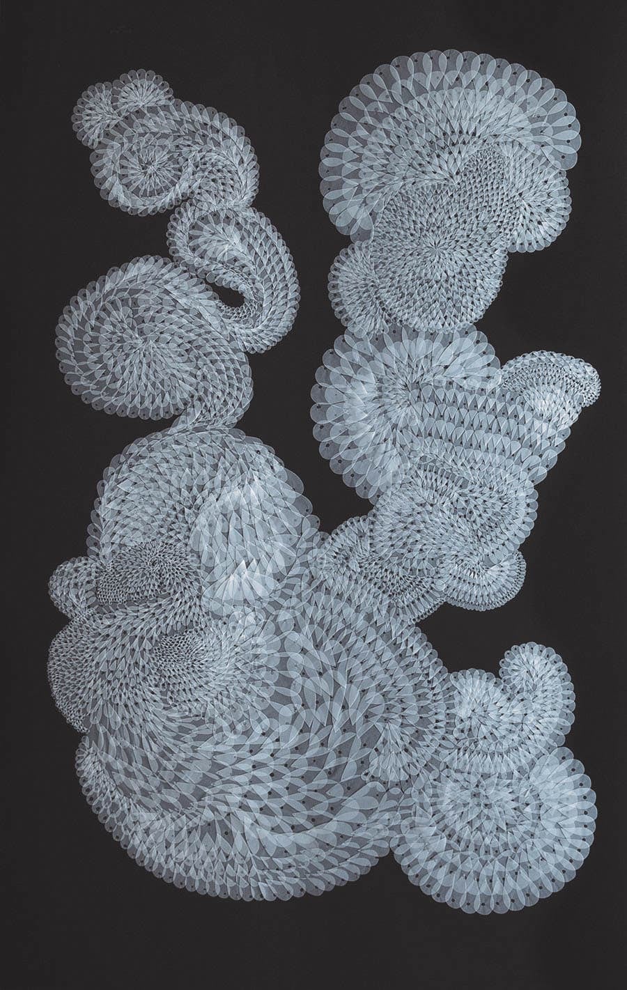 An intricate paper sculpture resembling abstract, cloud-like formations against a black background.