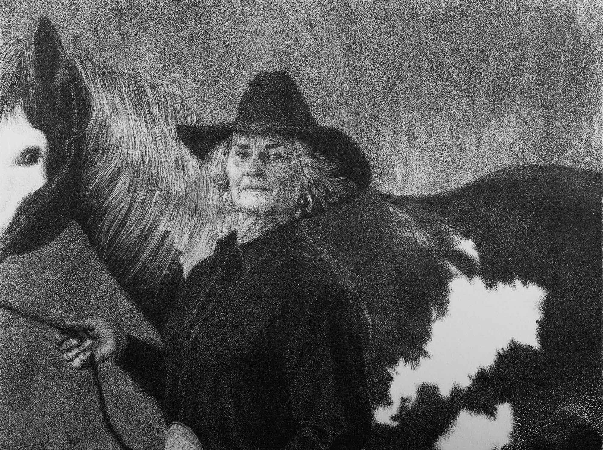 A black and white portrait of an elderly woman in a cowboy hat standing beside a horse.