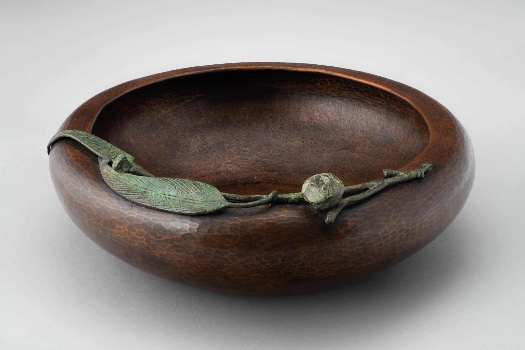 Copper Arts & Crafts bowl with leaf detail along the lip