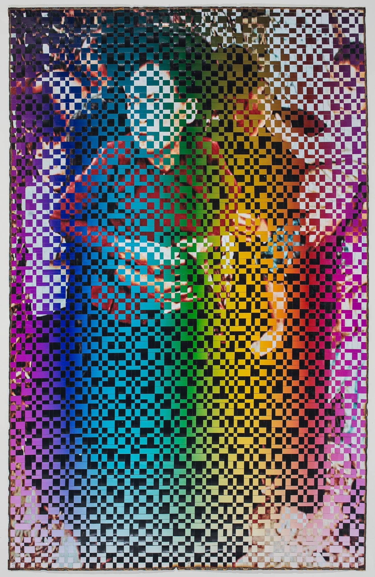 Rainbow pixelation over an image of a light-skinned person wearing a red shirt. Most of the underlying image is obscured by the pixels.