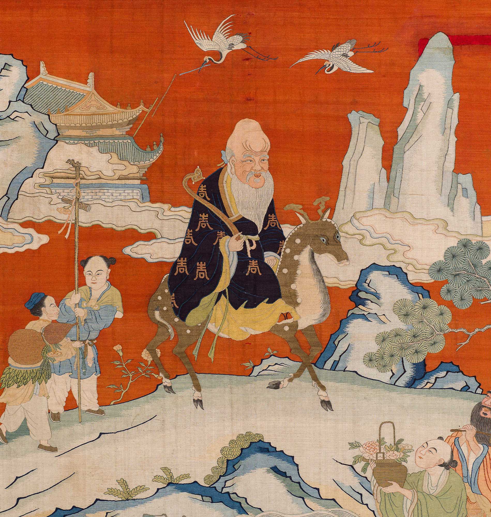 Orange tapestry with an elderly man in a dark blue robe riding a deer-like animal with a pagoda, cranes, and mountains in the background