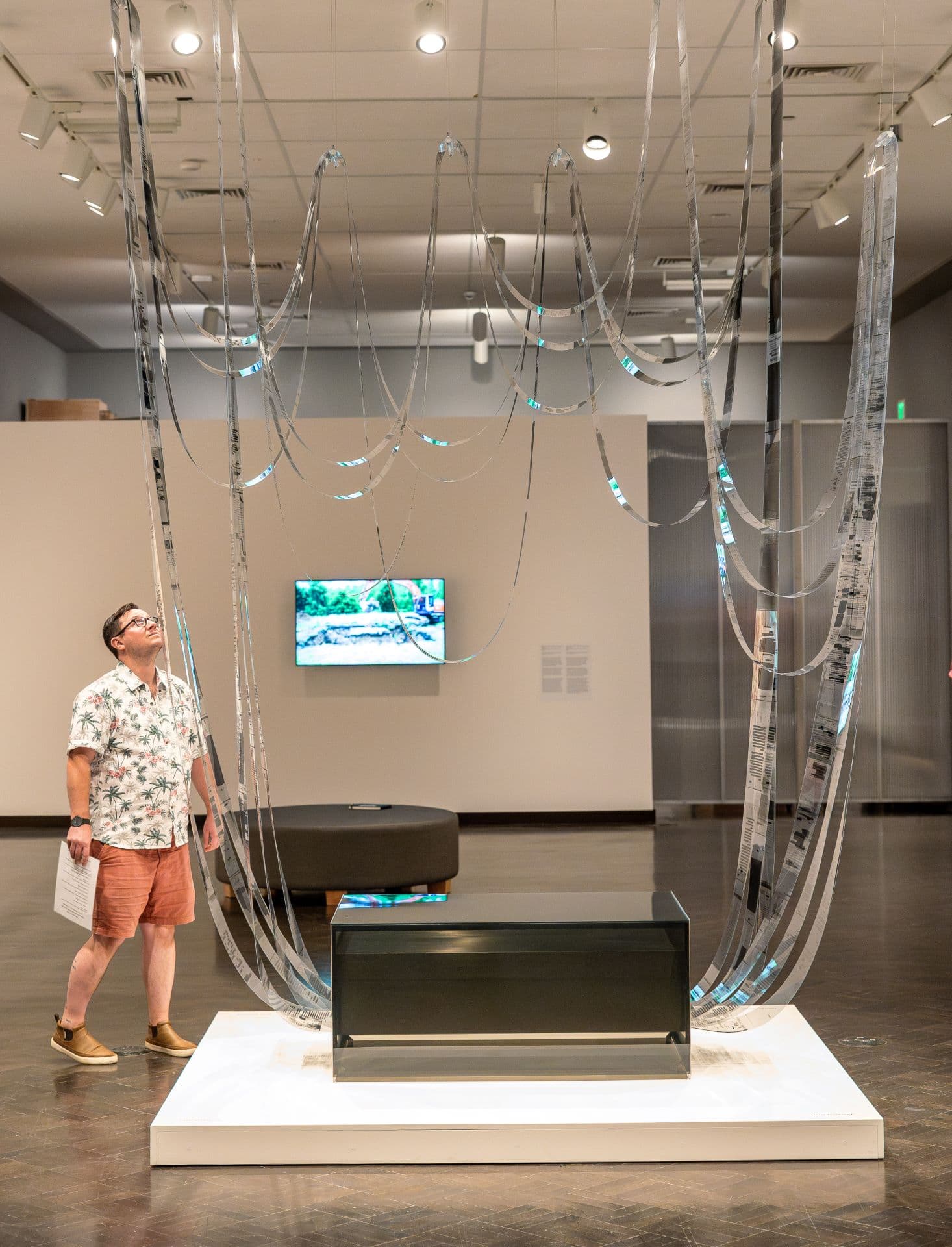 Man looks up at Vouspa Jarpa's work installed at the JSMA