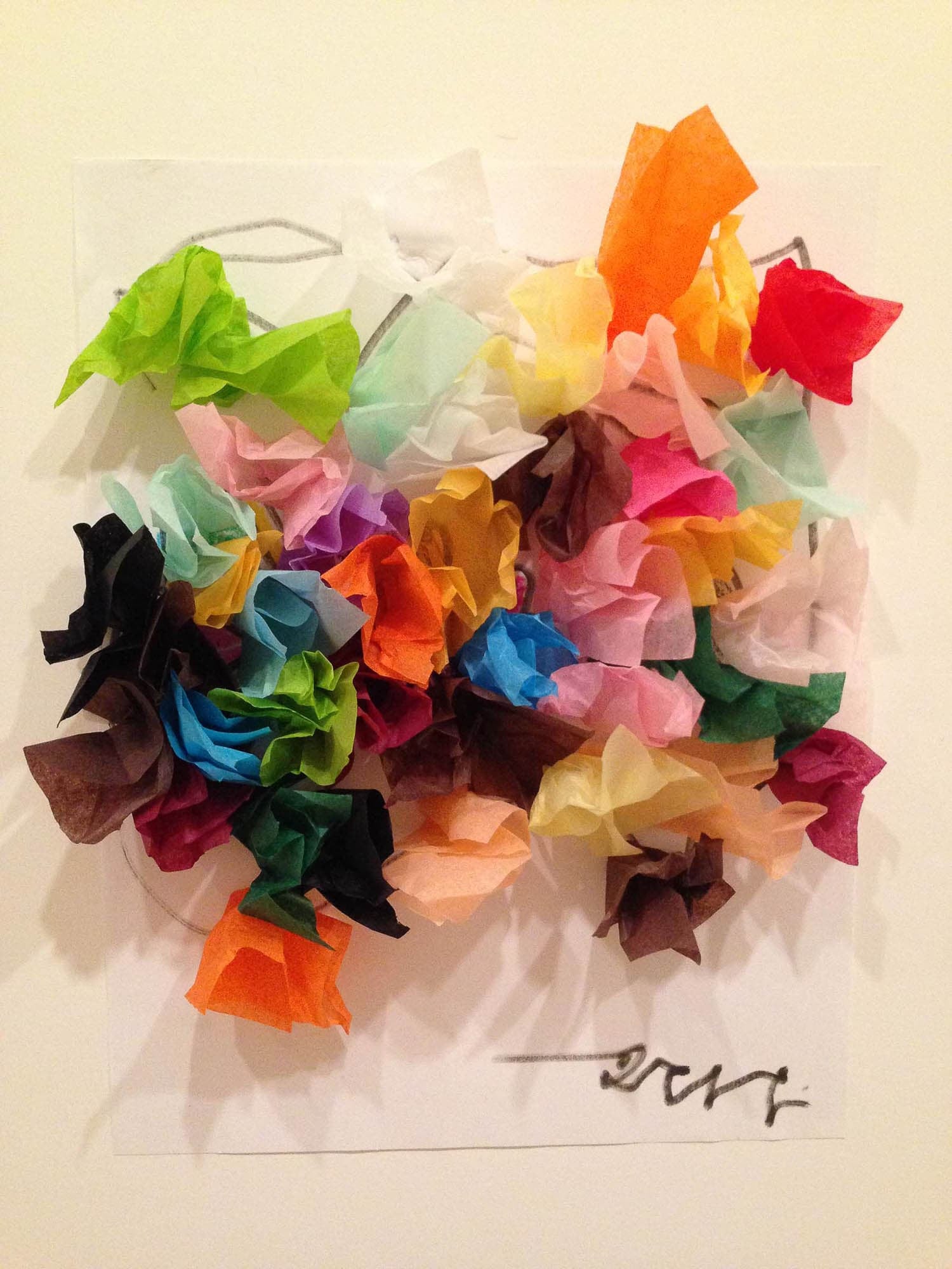 Brightly colored crumpled tissue paper formed like a circular bouquet