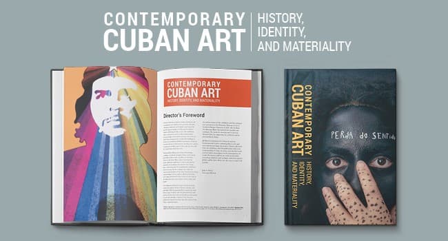 Inside the book is a full page artwork of Che Guevara with a rainbow emitting from a star on his forehead. On the book cover, a person with their face painted black holds a paint dotted hand in front of their mouth and nose, staring wide-eyed at the viewer.