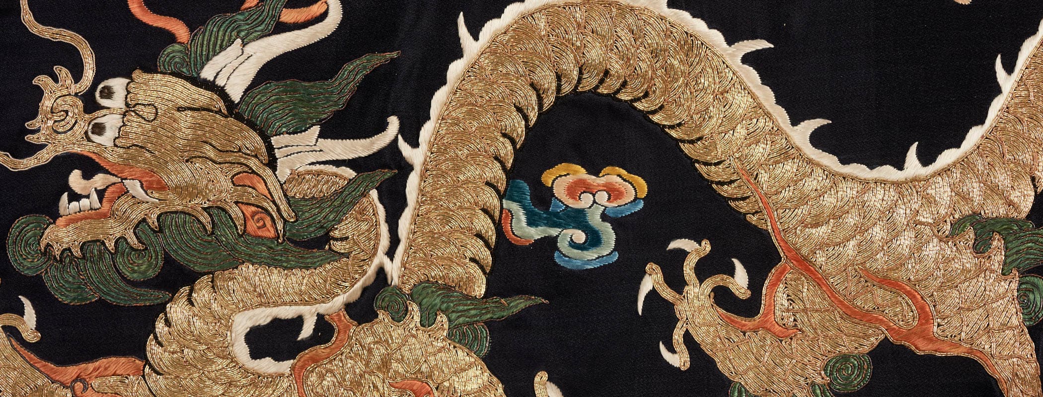 A golden dragon embroidered on a black background