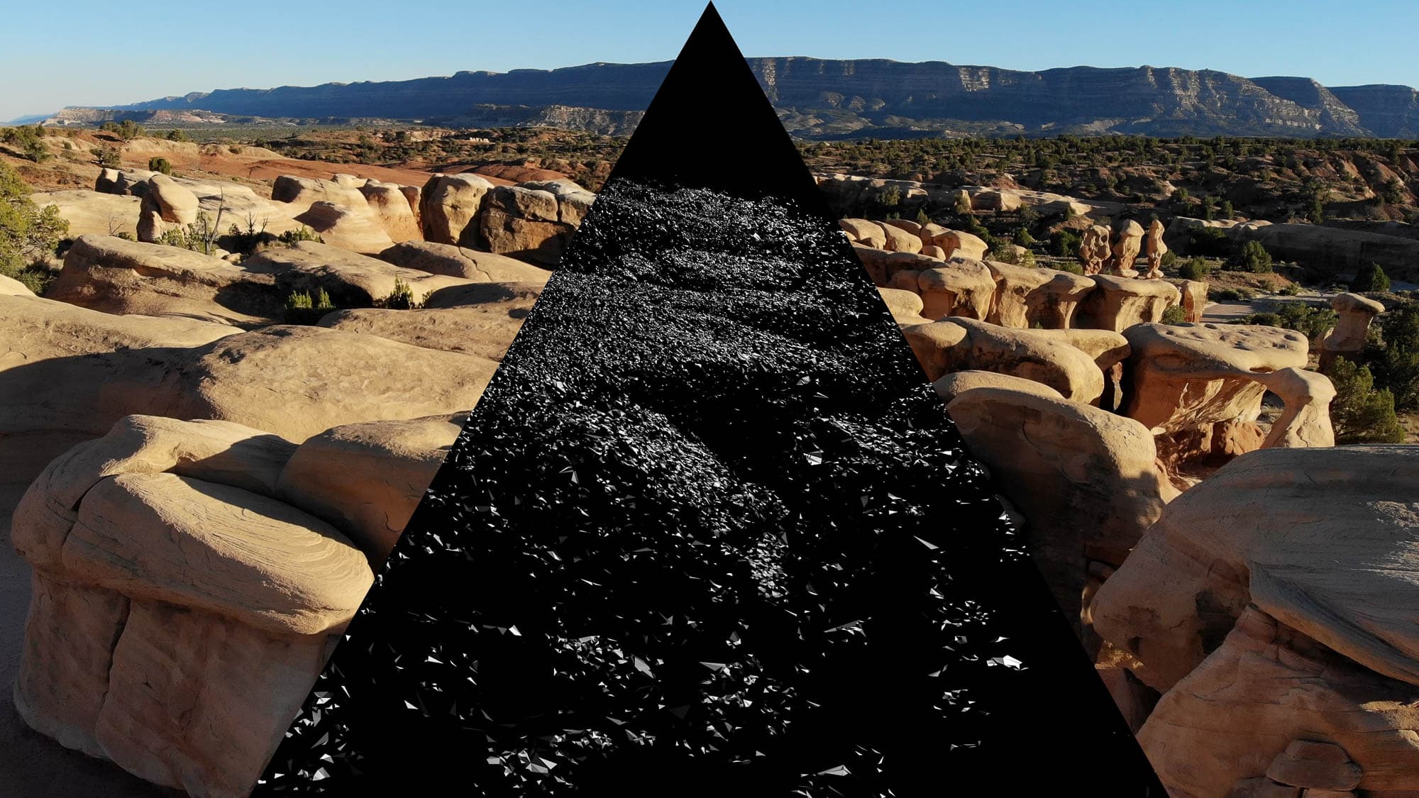 A landscape photo of a rocky desert area with a triangular section replaced by a black textured surface.