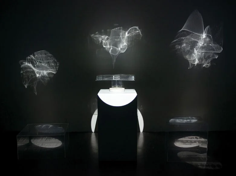 Installation image of a projected art, very dark, black and white.