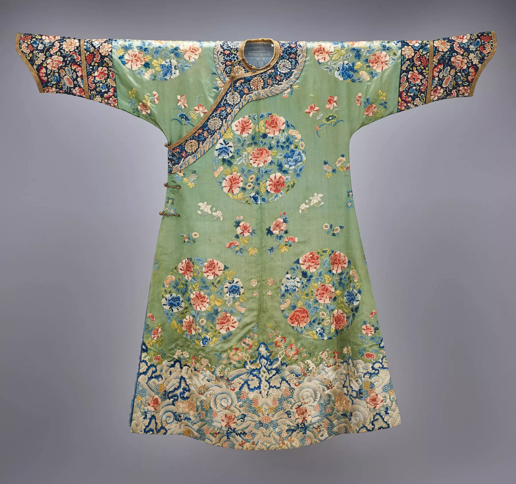 Pale green Chinese coat embroidered with red, white, and blue flowers