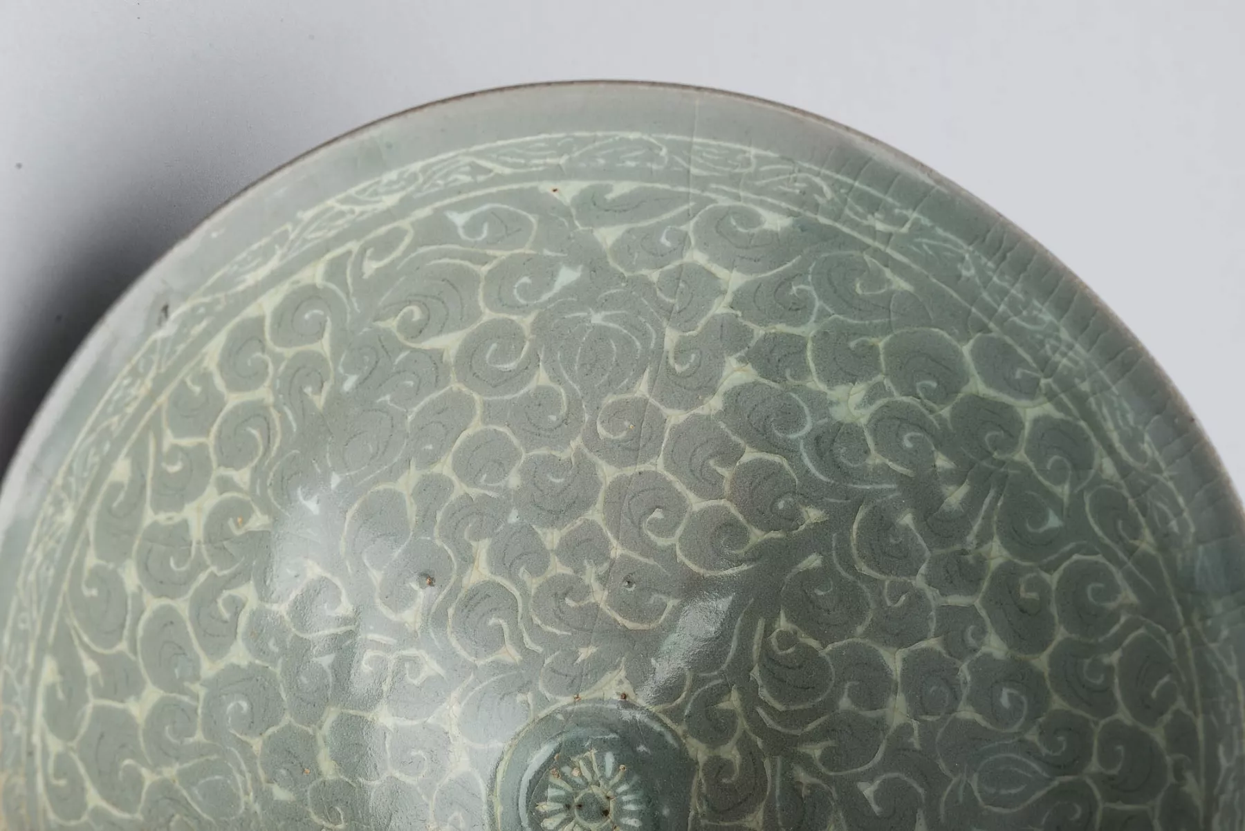 Part of a plate with gray swirls in cracking glaze