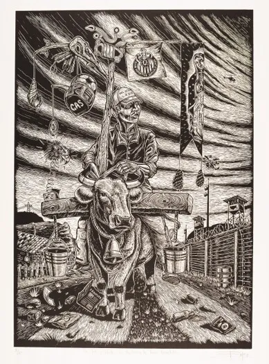 A black-and-white print featuring a man riding a large bull down a dirt trail strewn with trash and debris. The bull wears a large cowbell around its neck and is yoked to a heavy wooden beam that balances two metallic buckets on either side. Rising from behind the rider is a tall wooden staff decorated with various cultural icons, including a flag with a sports crest, a long banner depicting the Virgin of Guadalupe, a soccer ball helmet labeled "GAS," and a coiled jack-in-the-box toy. To the right, a tall border fence topped with barbed wire and watchtowers stretches into the distance beneath a dark, swirling sky where a lone helicopter flies.