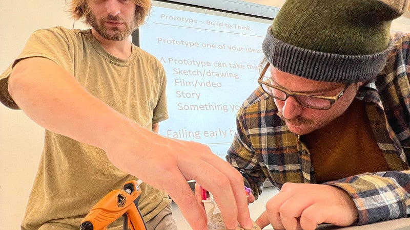 Two people work on a craft project