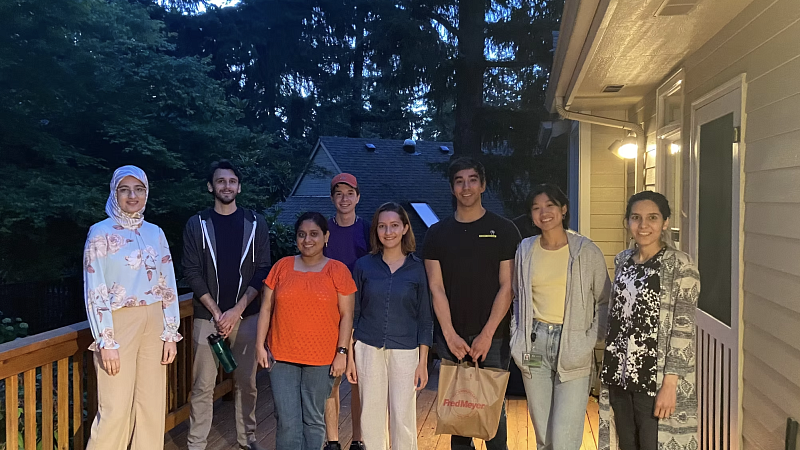 Group of people on a porch, smiling and looking at the camera