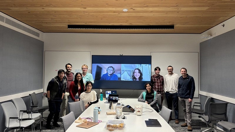 Group in front of a screen zoom call