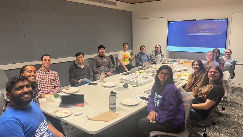 group eating pizza in a conference room 