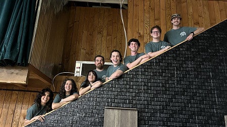 Students at the BRIN showcase event during Eugene Beer Week, standing on a staircase and smiling