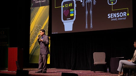 Ghee Ong presenting on stage at science knight out