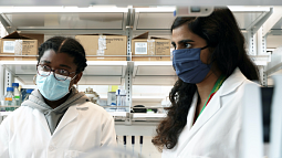 Knight Campus assistant professor Marian Hettiaratchi (right) in the lab with student