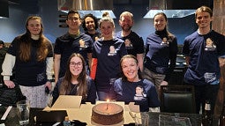 Students and faculty member in blue t shirts