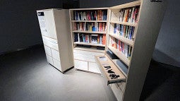A tall bookcase with doors and drawers