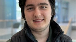 Oliver Loreto standing in the Knight Campus lobby